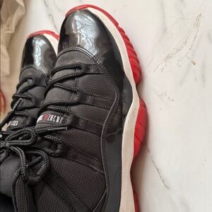 Jordan 11 Men's Black and Red Low-Top Retro Sneakers